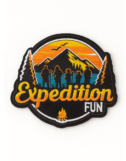 Gestickter Expedition Fun-Patch mit Berglandschaft, Wanderern und Sonnenuntergang. Auffälliges Outdoor-Design in Orange, Blau und Schwarz – ideal für Abenteuerliebhaber und Outdoor-Bekleidung.