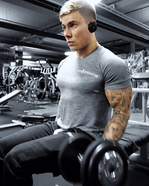 Athlet im grauen Gym Generation Shirt zeigt sportlichen und stylischen Gym-Look