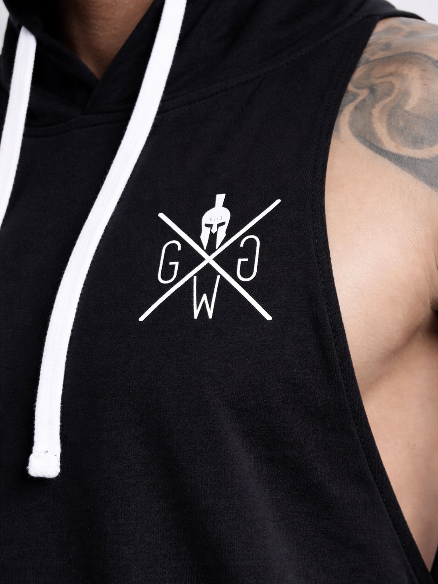 Detailaufnahme vom schwarzen Kapuzen Tank Top von Gym Generation – weißes Brustlogo auf ärmellosem Fitness Hoodie