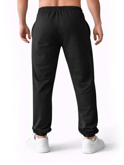 Rückansicht der schwarzen Gym Generation Herren Jogginghose mit Baggy Fit aus French Terry, elastischem Bund und lockerem Sitz für Rest Day und Freizeit
