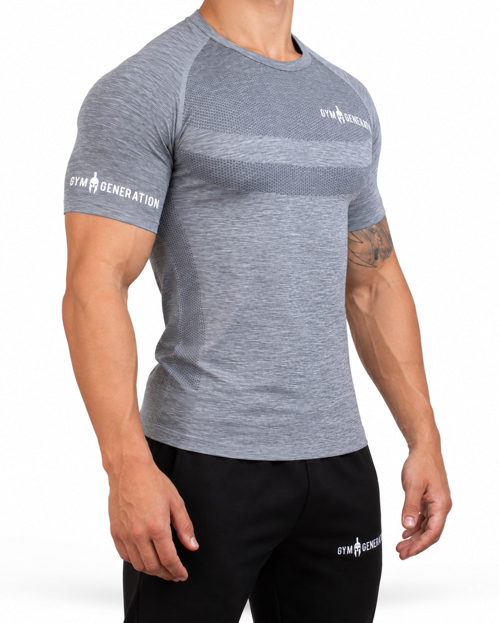 Gray men's seamless sport shirt from a three-quarter angle, close-fitting with raglan sleeves, honeycomb knit on chest and flank and lettering on the sleeve