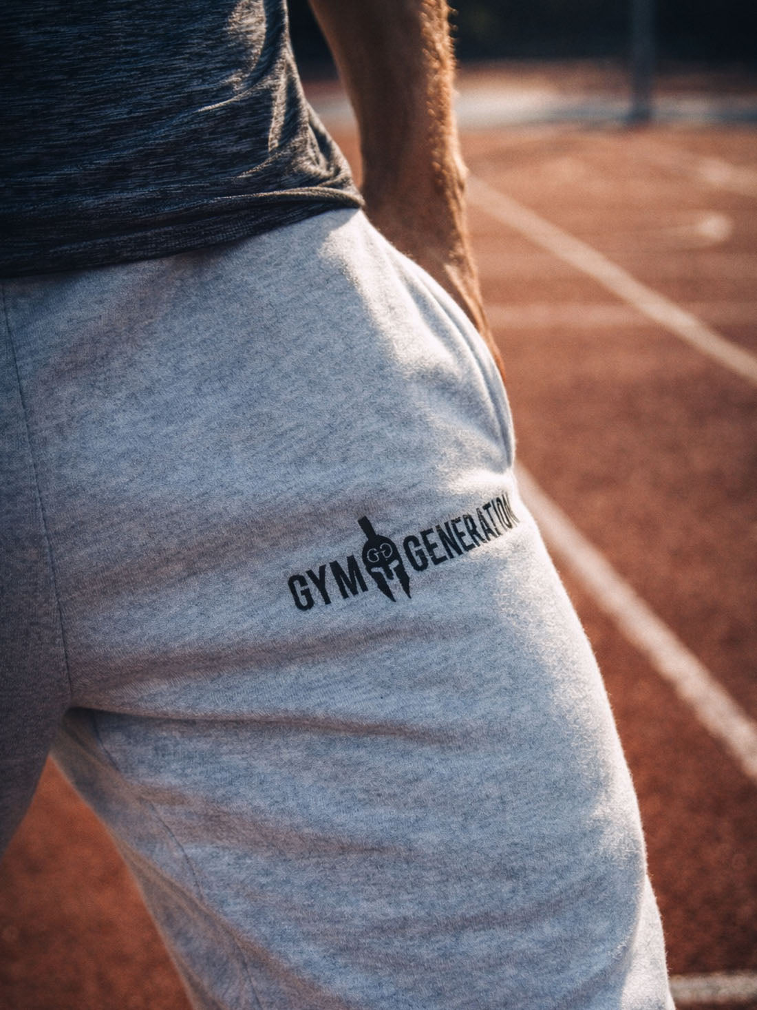 Gym Generation Herren Trainingshose grau – Logo-Detail im sportlichen Lifestyle-Umfeld