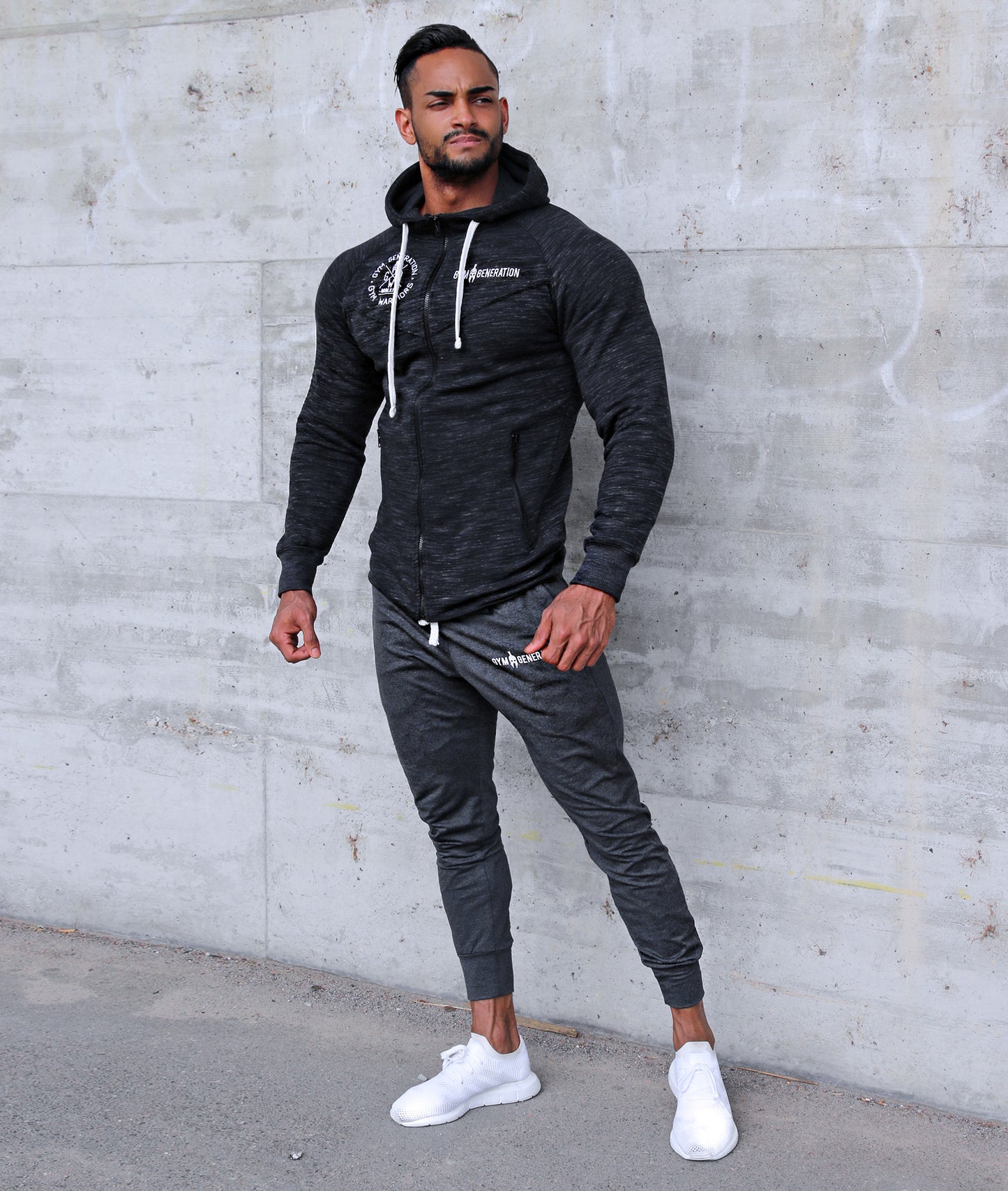 Dark grey fitness hoodie with zippered pockets for secure storage during workouts
